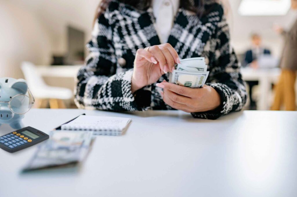 Women counting money, trying to save money